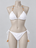 Golden Hour white bikini on a display mannequin; AI-assisted styling visualization. Original product photo retained.