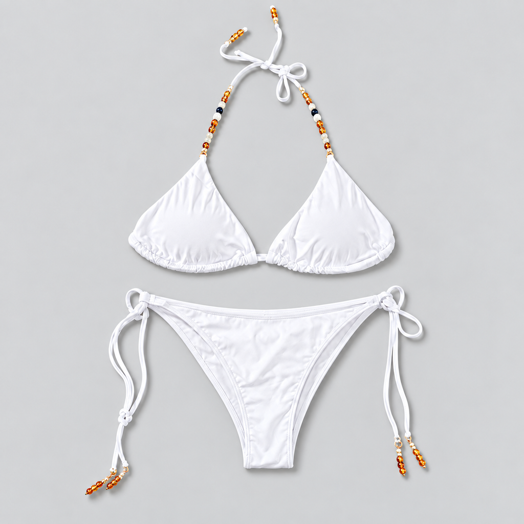 Golden Hour white bikini flat lay on light grey background; AI-assisted image cleanup.