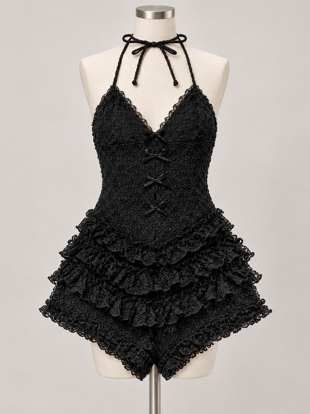 Lost in You Ruffle Romper Black on an ivory dress form; AI-generated styling visualization. Refer to original product photos for garment details.