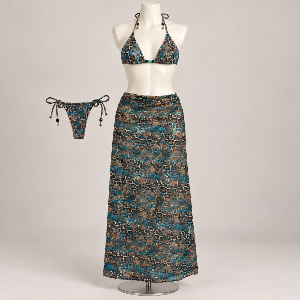 Resort Annie Bikini Set Brown/Blue (No Promo) on an ivory display mannequin; AI-generated styling visualization. Original product photos retained for reference.