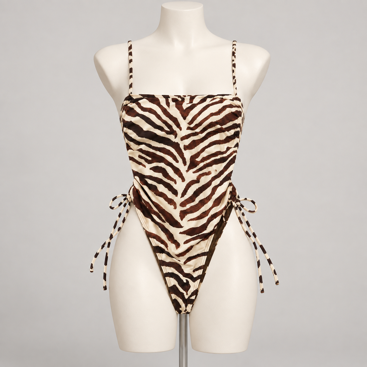 Resort No Pressure One Piece Swimsuit Tiger (No Promo) on an ivory display mannequin; AI-generated styling visualization. Original product photos retained for reference.